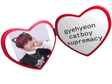 a heart shaped mirror with a picture of a boy and the words gyehyeon catboy supremacy on it