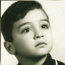 a black and white photo of a young boy