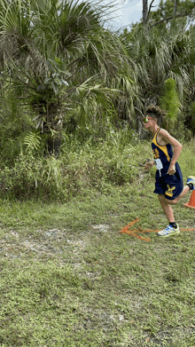 a runner wearing a blue and yellow jersey with the letter s on the front