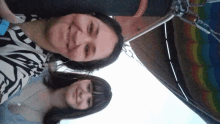 two women are smiling in front of a hot air balloon that says hawaii