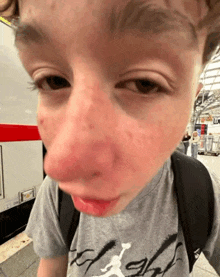 a young boy wearing a grey shirt that says flight