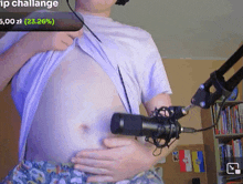 a man is holding his belly in front of a microphone with the words ip challenge on the bottom right