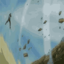 a person is flying through the air in a tornado with rocks flying in the air .