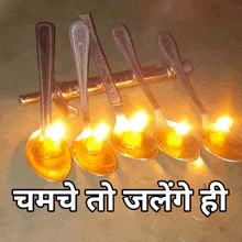 a row of spoons with candles in them and the words " chame to jalene hi " below them