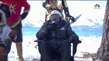 a man sitting in a chair with a nbc logo on the bottom