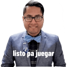 a man wearing glasses and a bow tie has a sticker on his jacket that says listo pa juegar