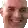 a close up of a man 's face with a blurred background .