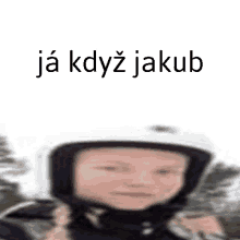 a blurry picture of a person wearing a helmet with the words `` ja když jakub '' written on the bottom .