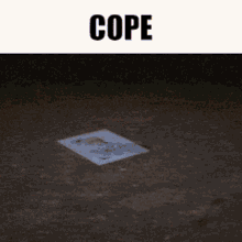 a piece of paper with a picture of a person on it is laying on the ground under the word cope