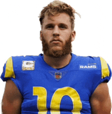 a man with a beard wears a blue and yellow rams jersey