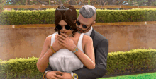 a man in a suit and a woman in a white dress are hugging each other