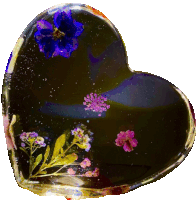 a heart shaped object with purple flowers on it