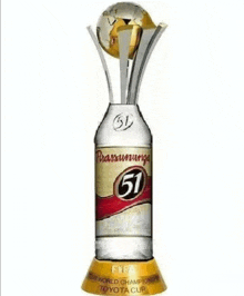 a trophy that looks like a bottle of beer with a globe on top of it .