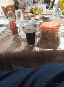 a table with a bottle of coca cola and a cup of coffee