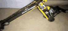 a yellow and black dodge dragster is sitting on the floor