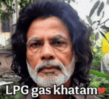 a man with long hair and a beard is wearing glasses and says lpg gas khatam