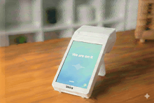 a white veira device is on a wooden table