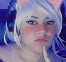 a woman wearing headphones and a cat ear wig