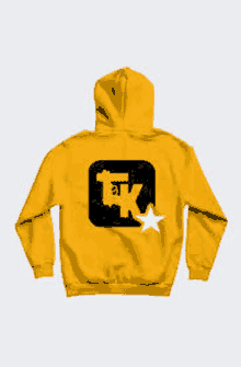 the back of a yellow hoodie with a black logo and a white star