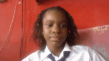 a young girl wearing a white shirt and blue tie