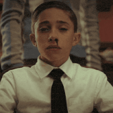 a boy with a cigarette in his nose
