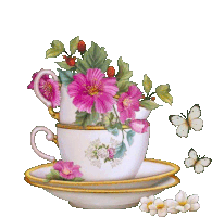 a teacup with pink flowers and butterflies on it