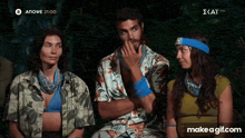 a group of people are sitting next to each other and one of them is wearing a headband that says ' ekat '