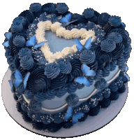 a heart shaped cake decorated with blue butterflies