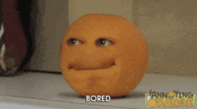 an orange with a face on it and the word bored below it