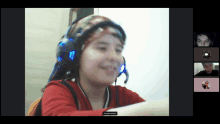 a girl wearing headphones and a headband is on a video call with four other people