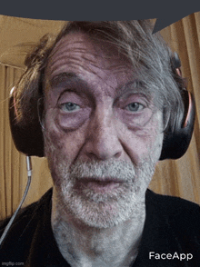 a man wearing headphones has a face app watermark on the bottom