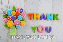 a bunch of colorful cookies are sitting on a table with the words `` thank you ladies '' written on them .