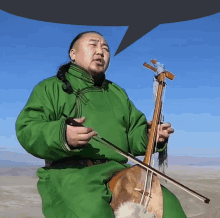 a man in a green outfit is playing a violin