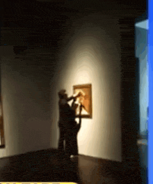 a blurry picture of people looking at a painting