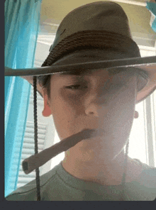 a person wearing a hat and smoking a cigar