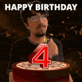 a man is blowing out a number four candle on a cake