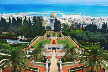 an aerial view of a garden with palm trees and a building with a dome on top