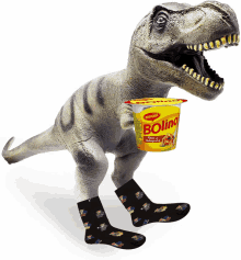 a toy dinosaur is holding a bowl of bollino