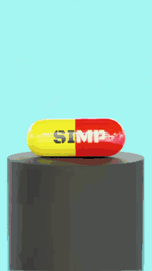 a yellow and red capsule that says simp on it