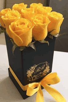 yellow roses in a black box that says r.r. on it