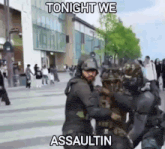 a group of police officers are standing on a street with a sign that says `` tonight we assaultin '' .