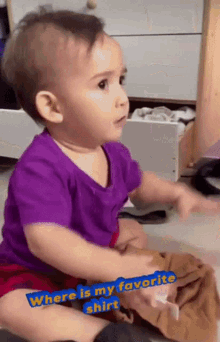 a baby in a purple shirt is sitting on the floor with the words " where is my favorite shirt "