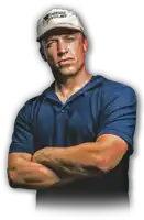 a man with his arms crossed wearing a tornado videos hat