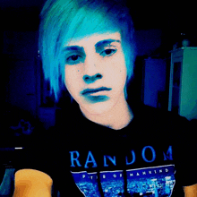 a young man with blue hair is wearing a random t-shirt