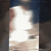 a blurry picture of a person in a white dress is displayed