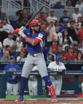a baseball player getting ready to swing at a ball in front of a fence that says world baseball classic