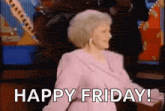 a woman is dancing in front of a television with the words `` happy friday '' written below her .