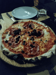 a pizza with pepperoni and olives on it