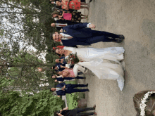 a bride and groom pose for a picture with their wedding party