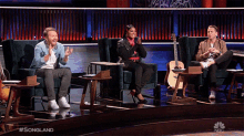 a group of people sitting in chairs on a stage with the words songland written on the bottom of the screen